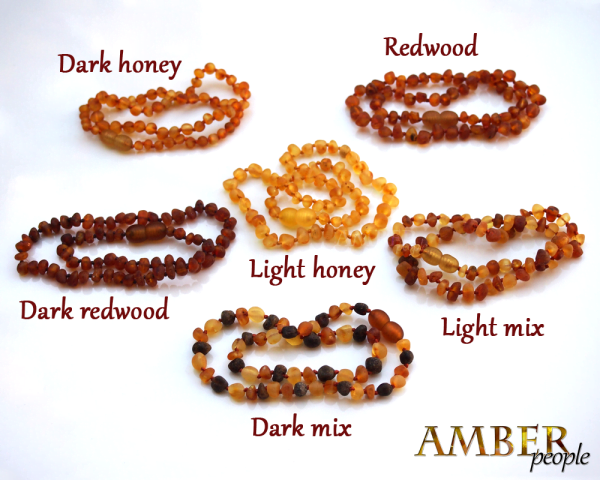 Baltic amber baby teething necklaces and bracelets in 6 raw amber unpolished colours - dark honey, light honey, redwood, dark redwood, light mix and dark mix, displayed together