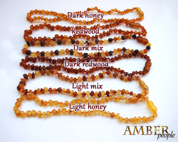 Baltic amber baby teething necklaces and bracelets in 6 raw amber unpolished colours - dark honey, light honey, redwood, dark redwood, light mix and dark mix, displayed together