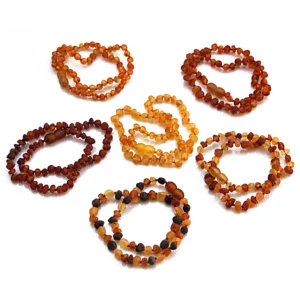 Baltic amber baby teething necklaces and bracelets in 6 raw amber unpolished colours - dark honey, light honey, redwood, dark redwood, light mix and dark mix, displayed together in the main product image