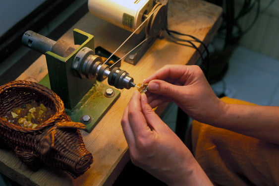 A man crafting Baltic amber jewellery, Amber People Online